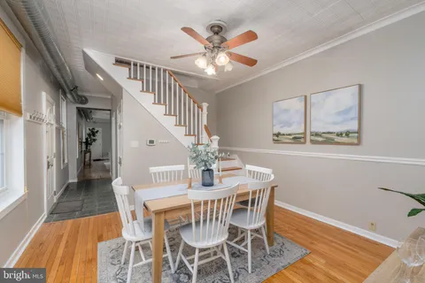 a view of a dining room with furniture wooden floor and a chandelier