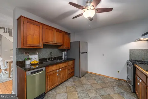 a kitchen with stainless steel appliances granite countertop a stove sink and cabinets