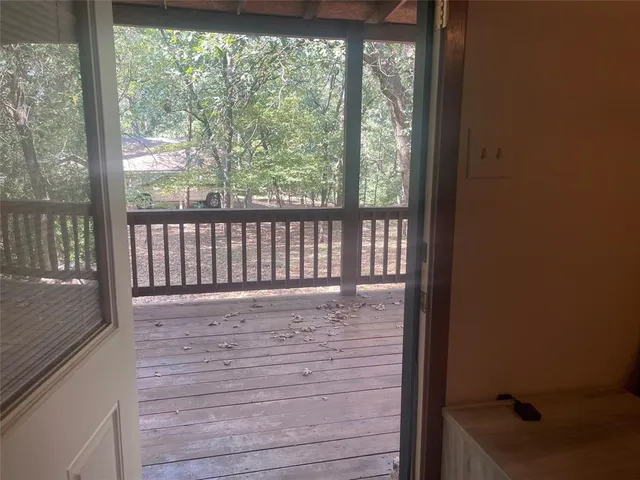 a view of a porch with wooden floor