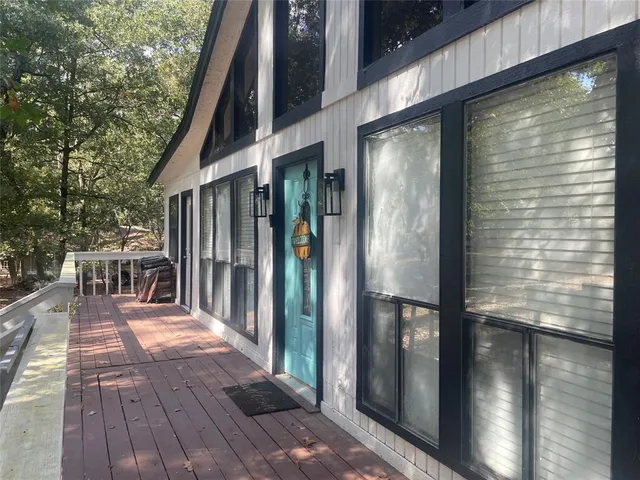 a view of a balcony with floor to ceiling windows with wooden floor
