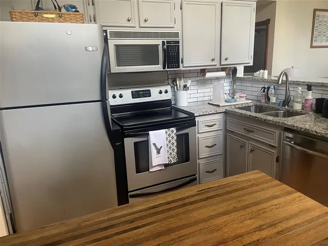 a kitchen with a stove microwave and refrigerator