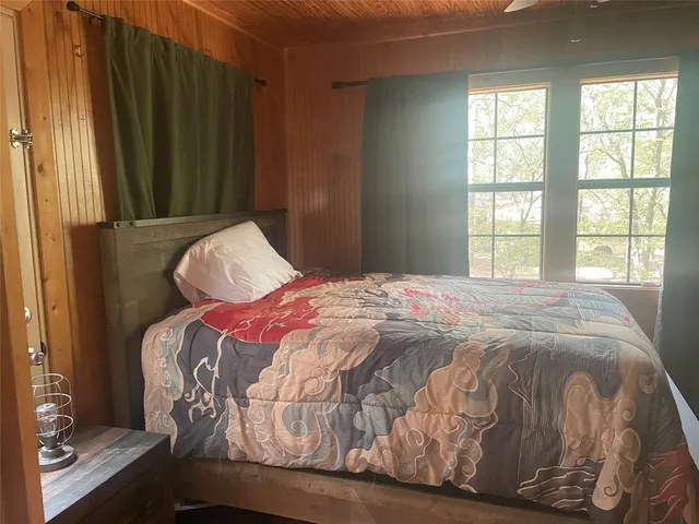 a bedroom with a bed and a window