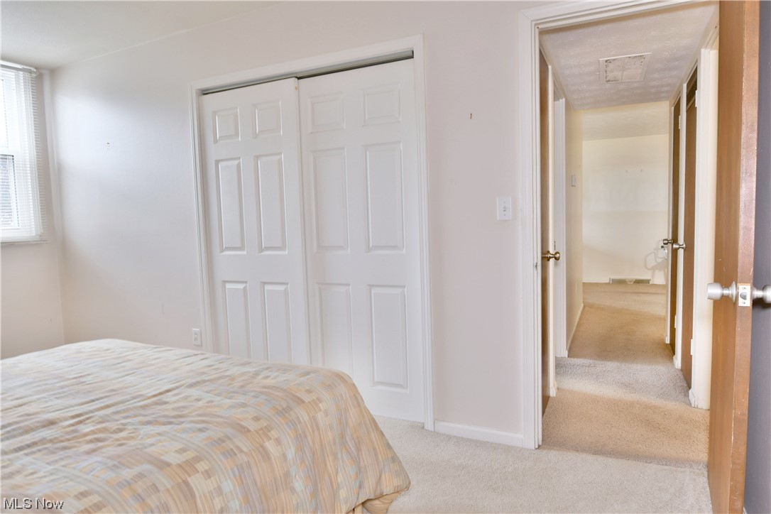 2980 North River Road Northeast, Unit E3 Warren, OH 44483 - Photo 25 of 27 Carpeted bedroom with a closet