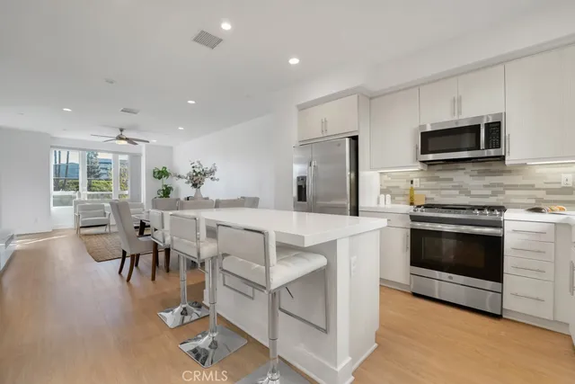 a kitchen with microwave a stove and furniture