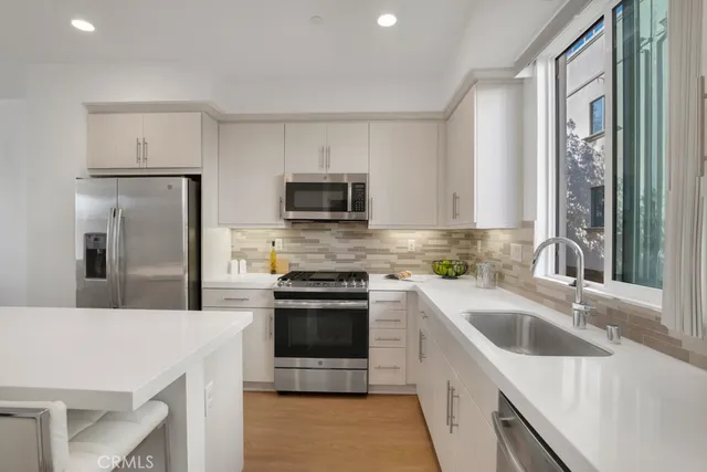 a kitchen with a sink stove and refrigerator