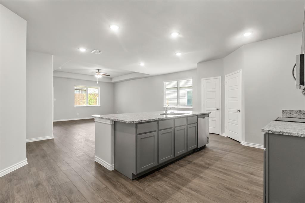 10656 Stag Lane Crowley, TX 76036 - Photo 4 of 13 a large kitchen with stainless steel appliances granite countertop a large counter top a sink and a refrigerator