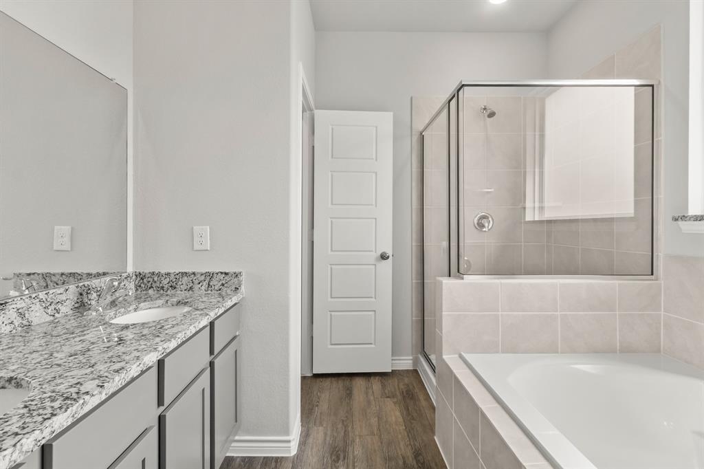 10656 Stag Lane Crowley, TX 76036 - Photo 7 of 13 a bathroom with a granite countertop sink a bathtub and shower
