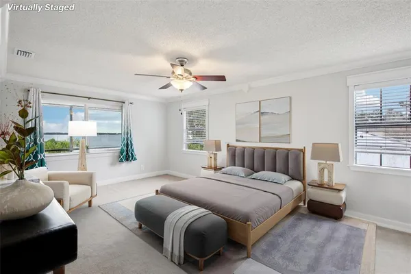an empty room with windows and chandelier fan