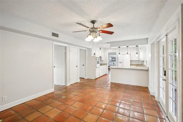 a view of a kitchen with a sink and a refrigerator