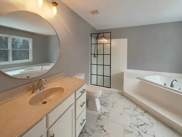 a bathroom with a sink toilet and tub