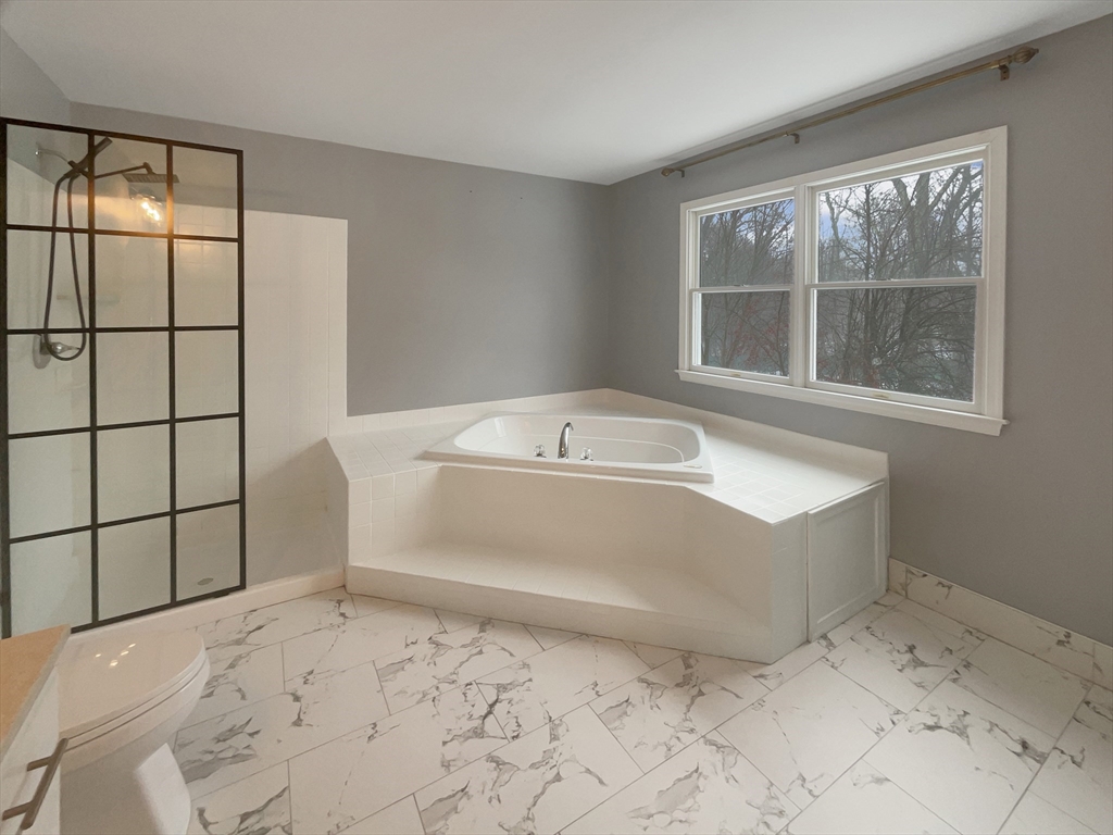 35 Peter Street Holliston, MA 01746 - Photo 21 of 38 a spacious bathroom with a bathtub and shower