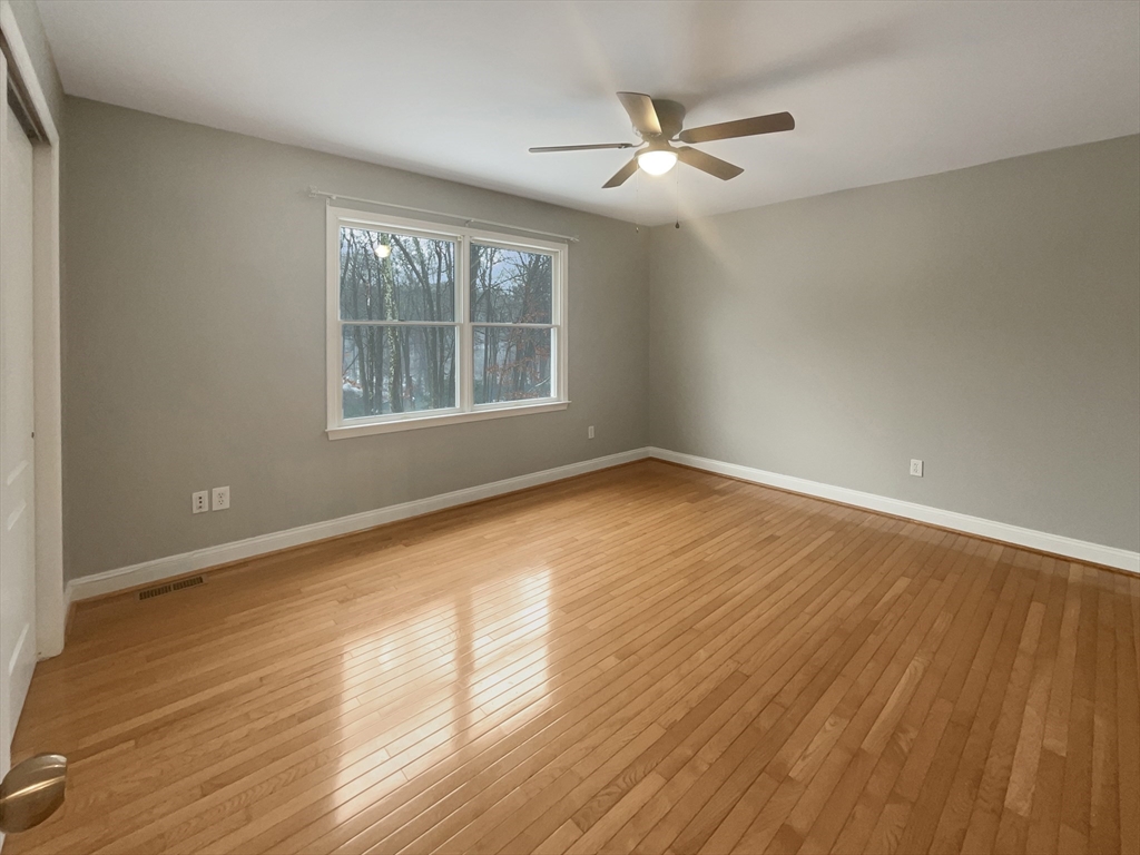 35 Peter Street Holliston, MA 01746 - Photo 23 of 38 a view of an empty room with wooden floor and a window