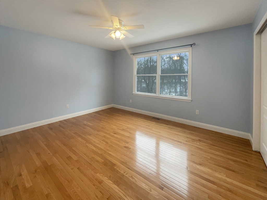 35 Peter Street Holliston, MA 01746 - Photo 24 of 38 a view of an empty room with wooden floor and a window
