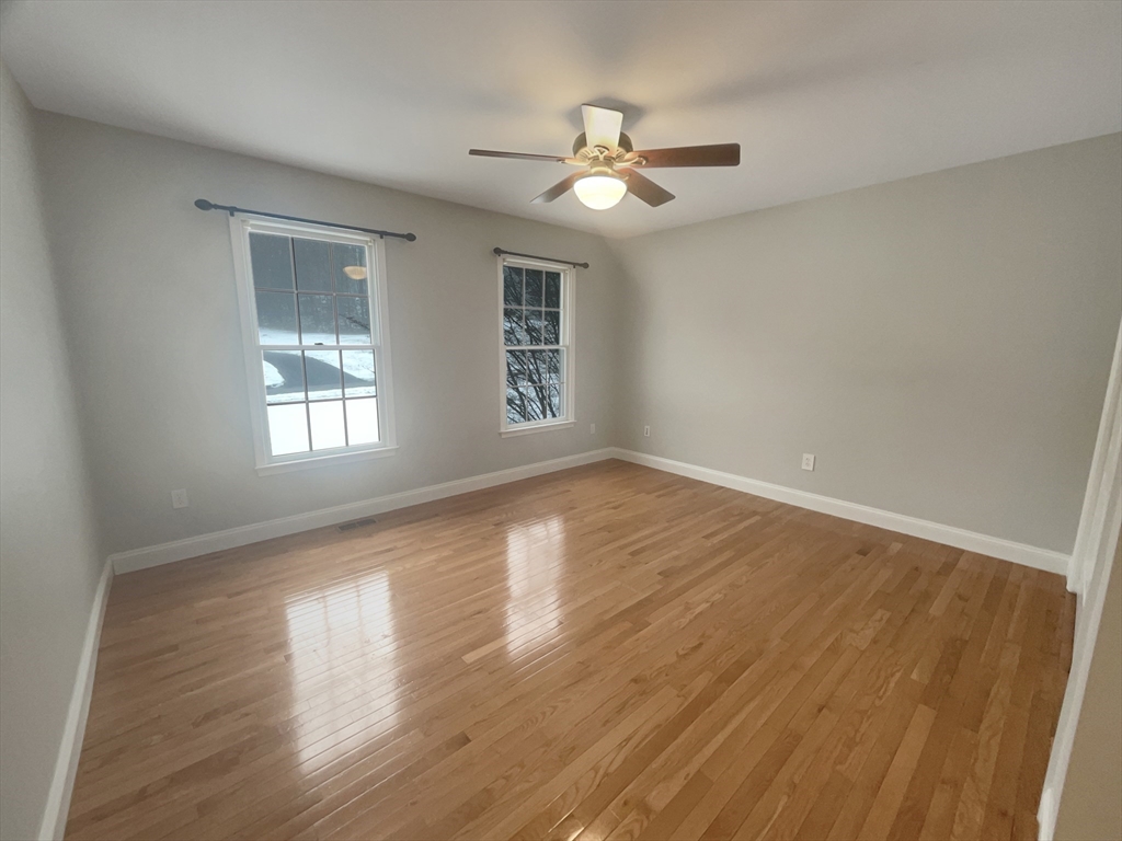 35 Peter Street Holliston, MA 01746 - Photo 26 of 38 a view of an empty room with wooden floor and a window