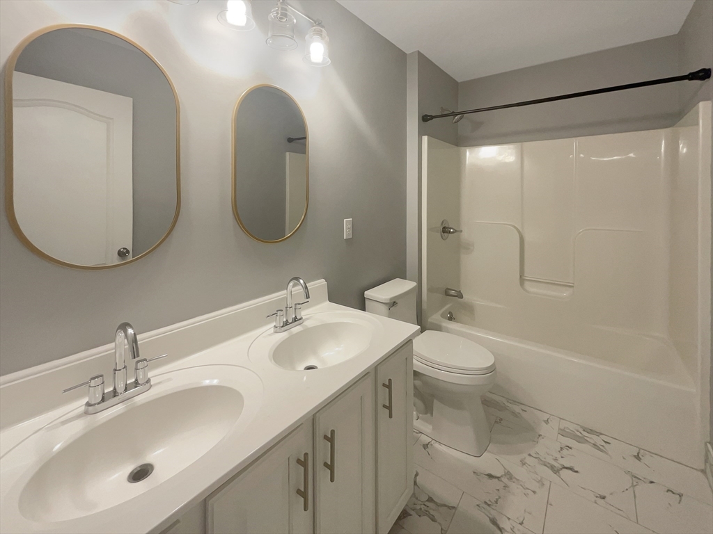 35 Peter Street Holliston, MA 01746 - Photo 28 of 38 a bathroom with a toilet sink and mirror