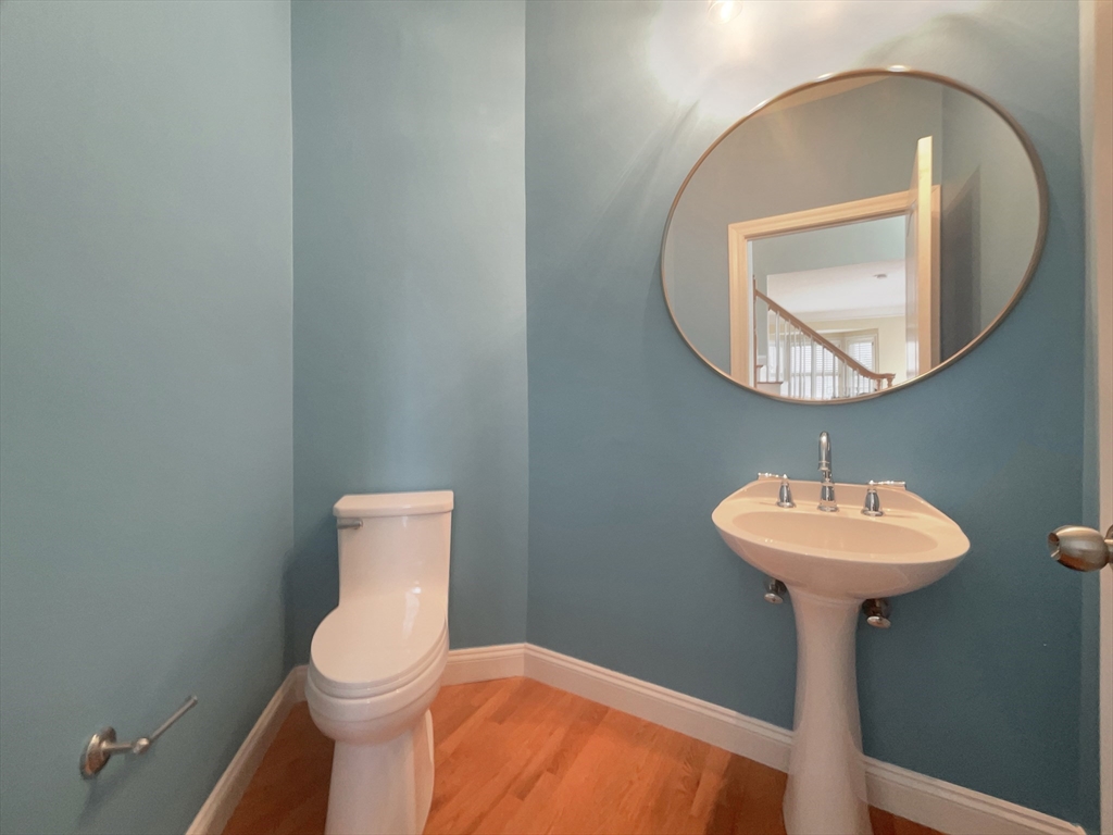 35 Peter Street Holliston, MA 01746 - Photo 30 of 38 a bathroom with a sink a mirror and a toilet