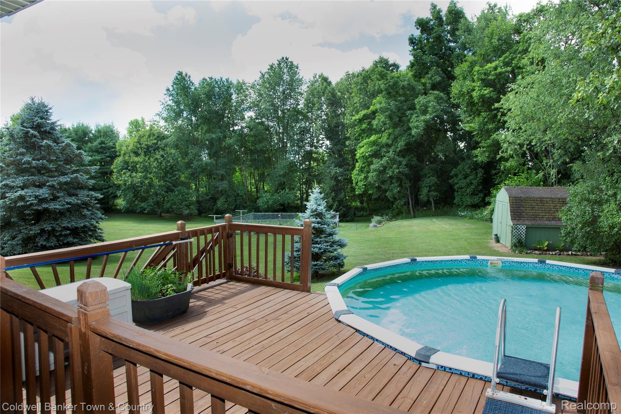17090 Rosehill Road Pinckney, MI 48169 - Photo 37 of 47 Pool with wrap around deck