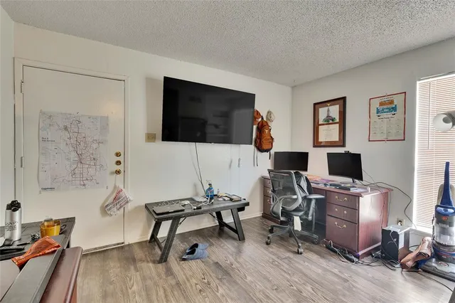 a view of a livingroom with workspace and a couch