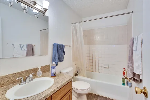 a bathroom with a sink toilet tub and shower