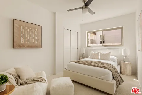 a bedroom with a bed and window