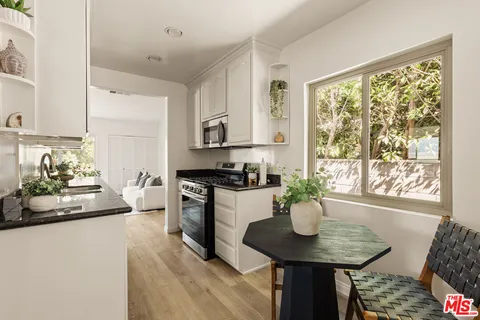 a kitchen with a table and chairs in it