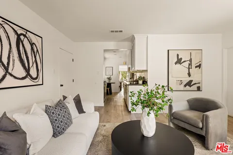 a living room with furniture potted plant and a window