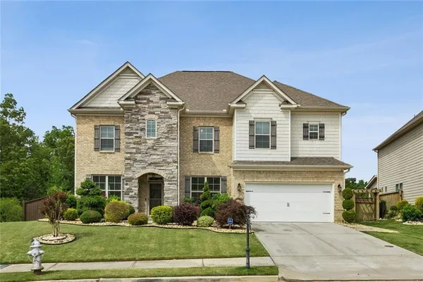 a front view of a house with a yard