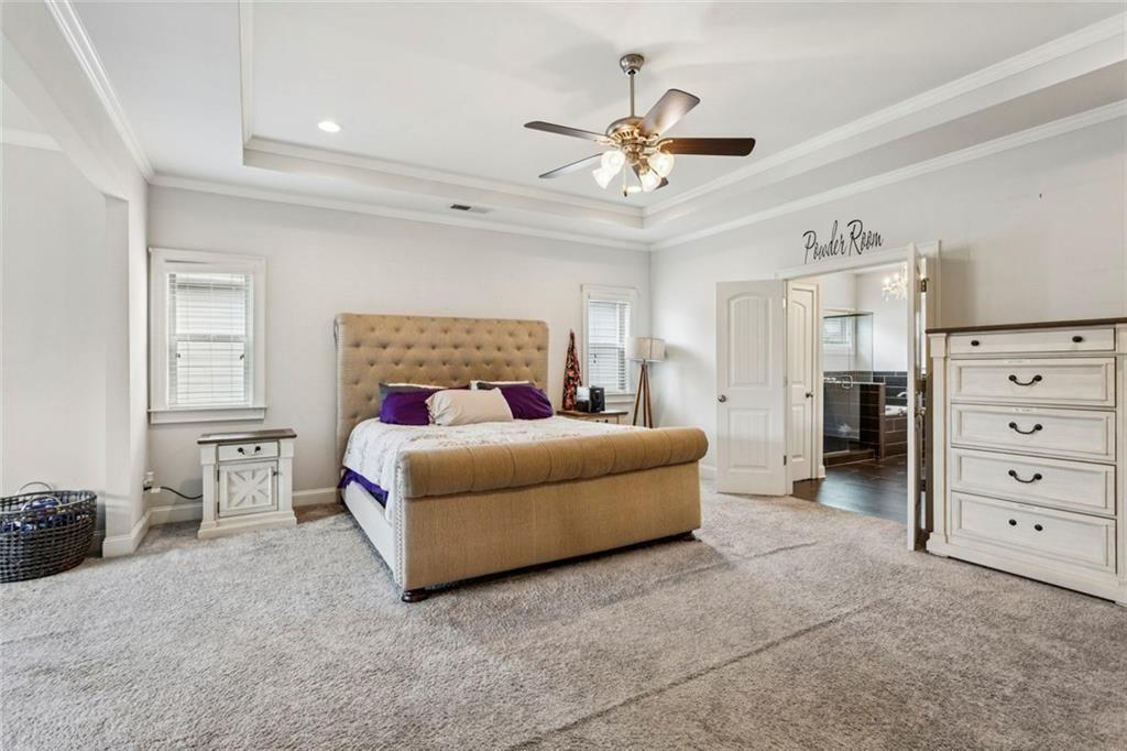 4846 Ralin Court Southwest Atlanta, GA 30331 - Photo 11 of 38 a bedroom with a large bed and ceiling fan