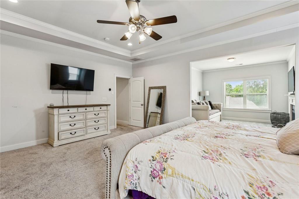 4846 Ralin Court Southwest Atlanta, GA 30331 - Photo 12 of 38 a bedroom with a bed a flat tv screen and a dresser
