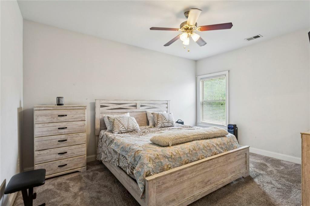4846 Ralin Court Southwest Atlanta, GA 30331 - Photo 16 of 38 a bedroom with a bed and a chandelier
