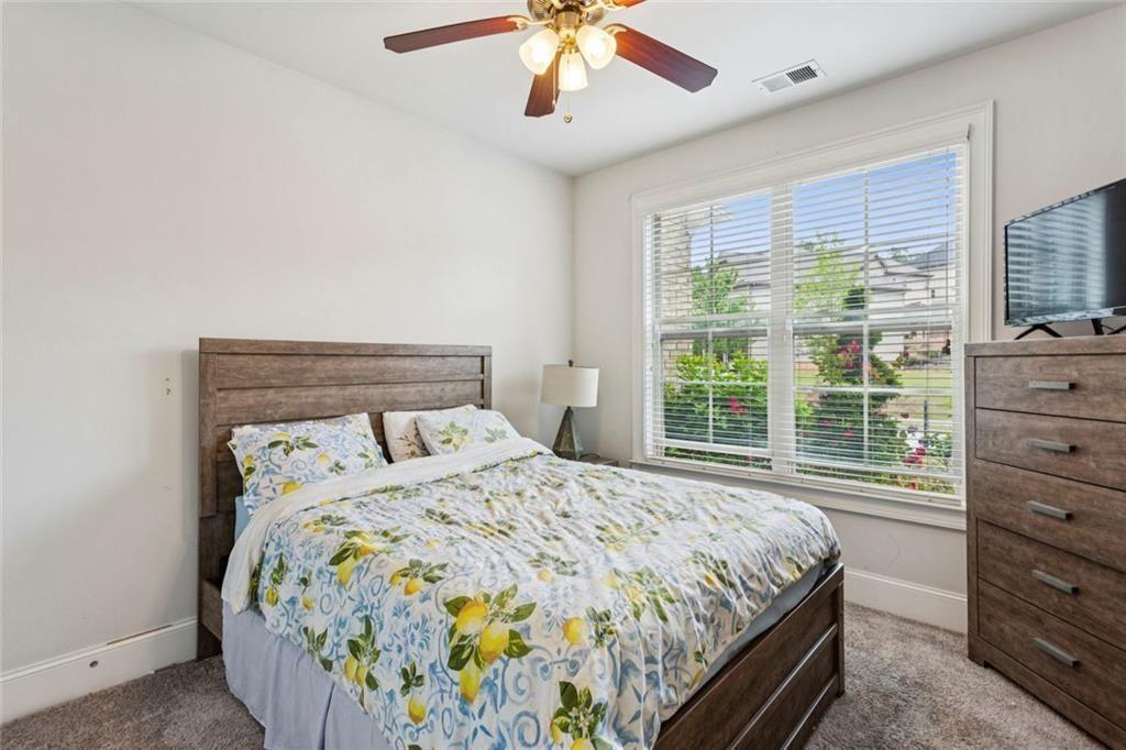 4846 Ralin Court Southwest Atlanta, GA 30331 - Photo 23 of 38 a bedroom with a bed and a chandelier