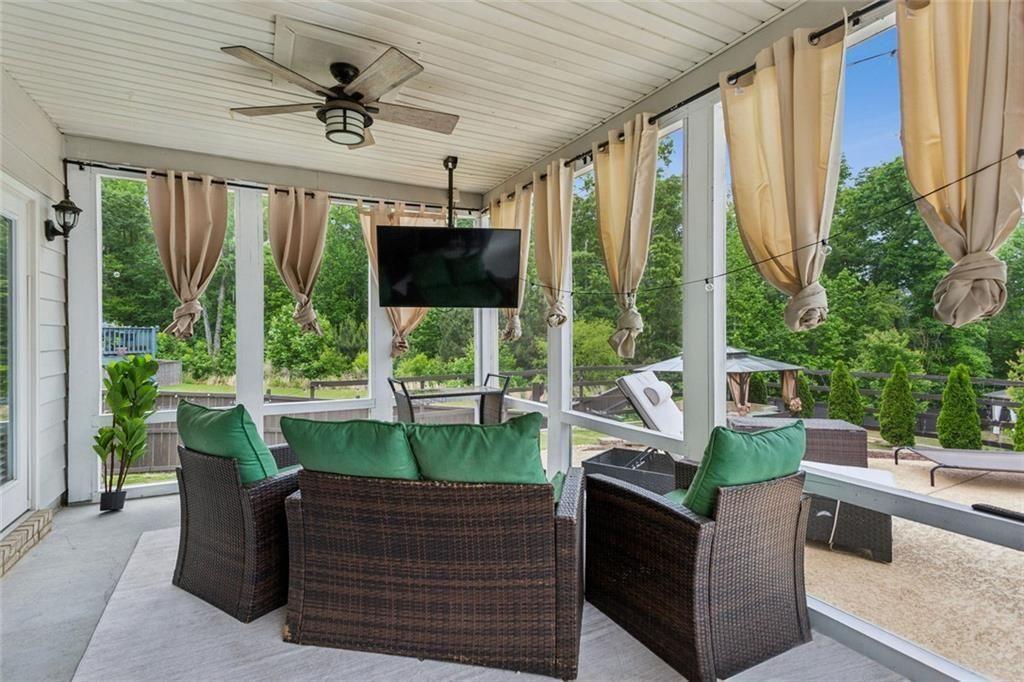 4846 Ralin Court Southwest Atlanta, GA 30331 - Photo 25 of 38 a living room with large windows a table and chairs