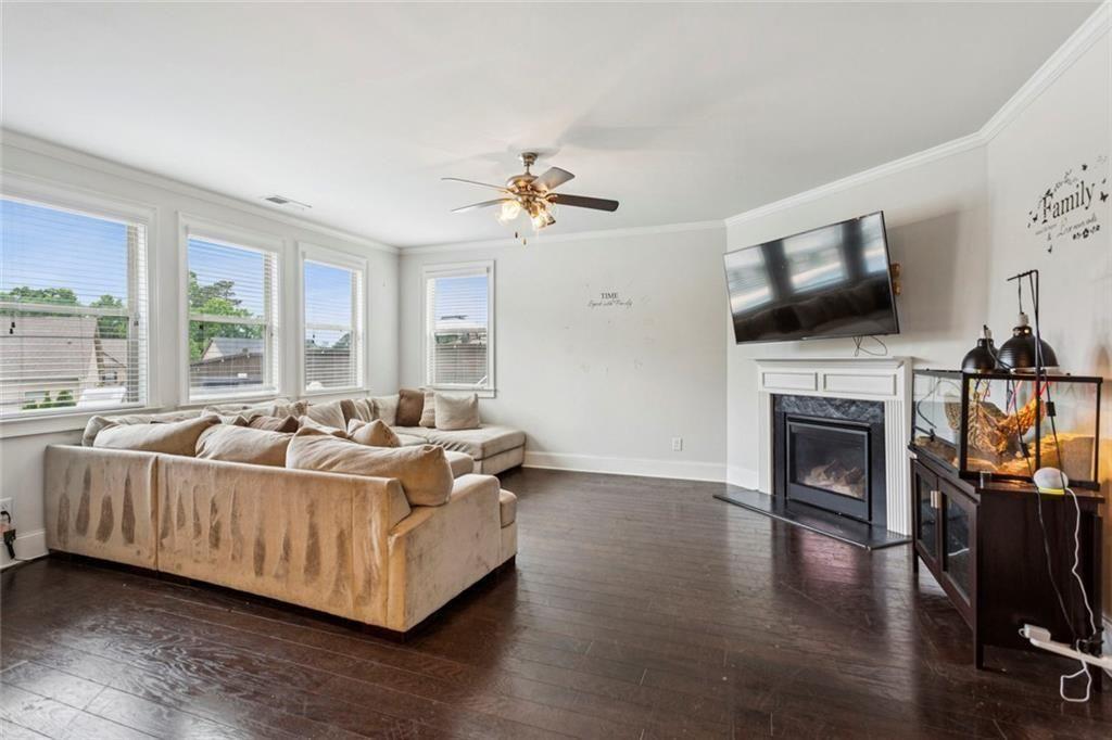 4846 Ralin Court Southwest Atlanta, GA 30331 - Photo 8 of 38 a living room with furniture a fireplace and a flat screen tv