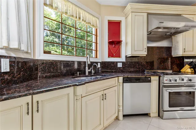a view of staircase with railing and a window