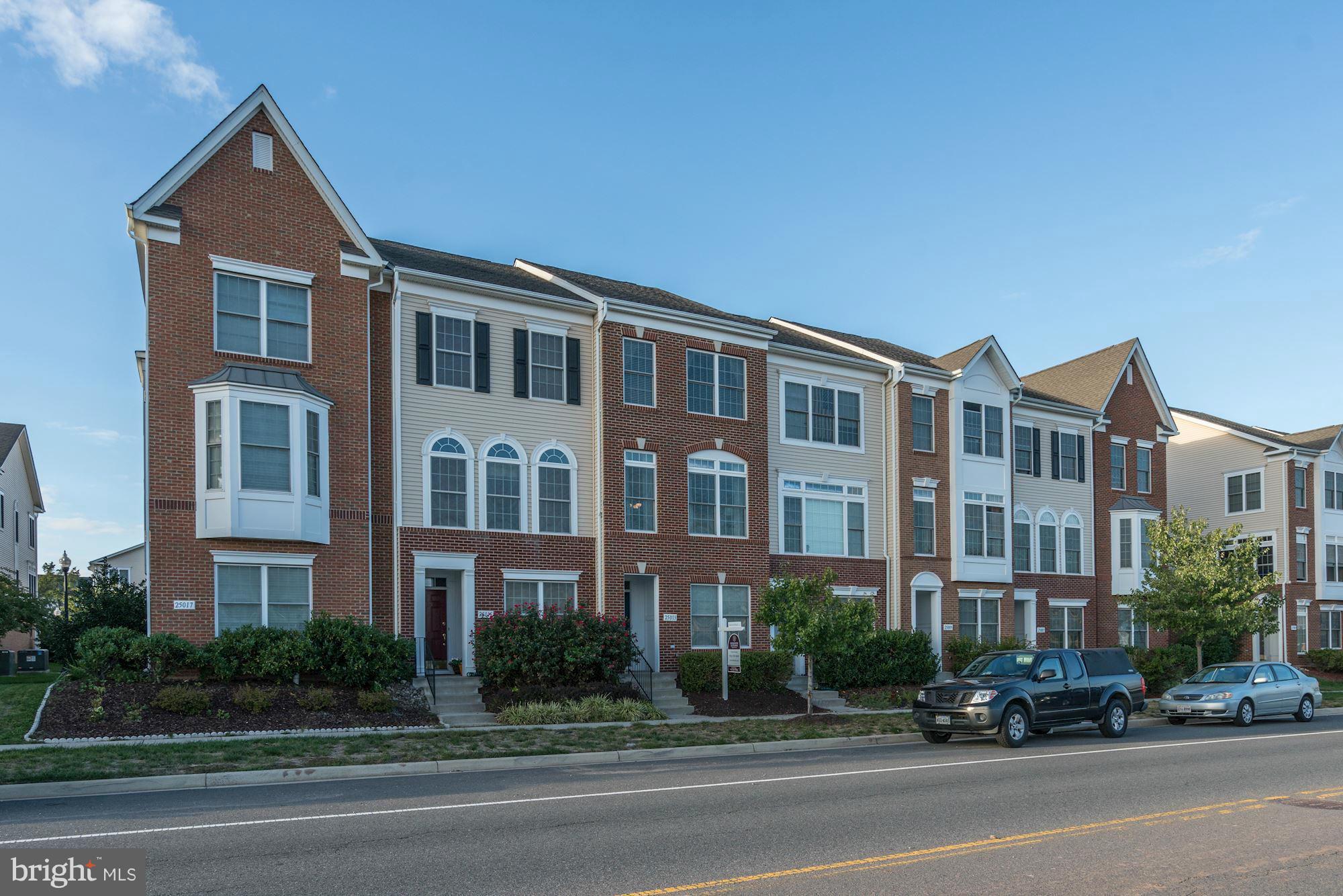 25013 Riding Center Drive Chantilly, VA 20152 - Photo 2 of 28 a city street lined with parked cars and buildings