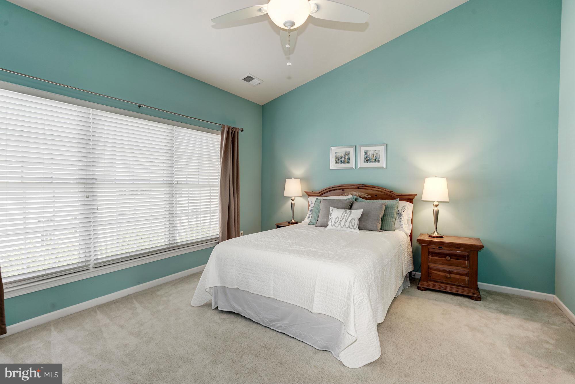 25013 Riding Center Drive Chantilly, VA 20152 - Photo 17 of 28 a bedroom with a bed and a large window