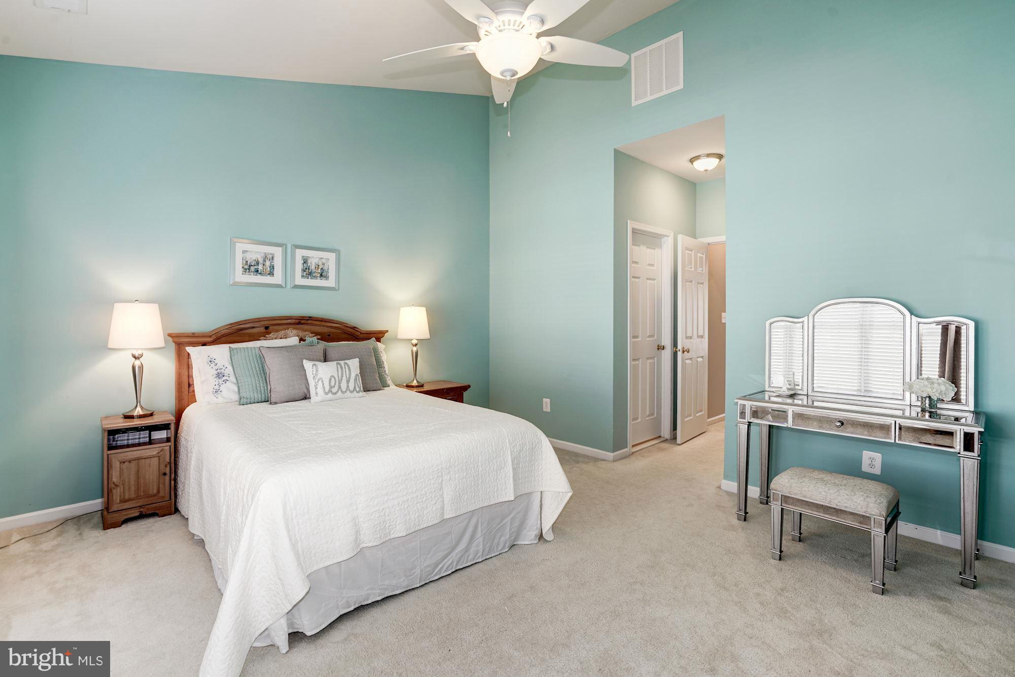 25013 Riding Center Drive Chantilly, VA 20152 - Photo 18 of 28 a bedroom with a bed and a chandelier