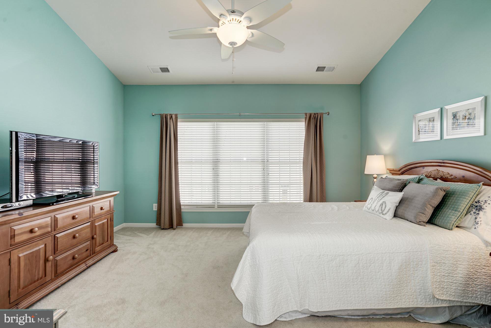 25013 Riding Center Drive Chantilly, VA 20152 - Photo 19 of 28 a bedroom with a bed and a flat screen tv