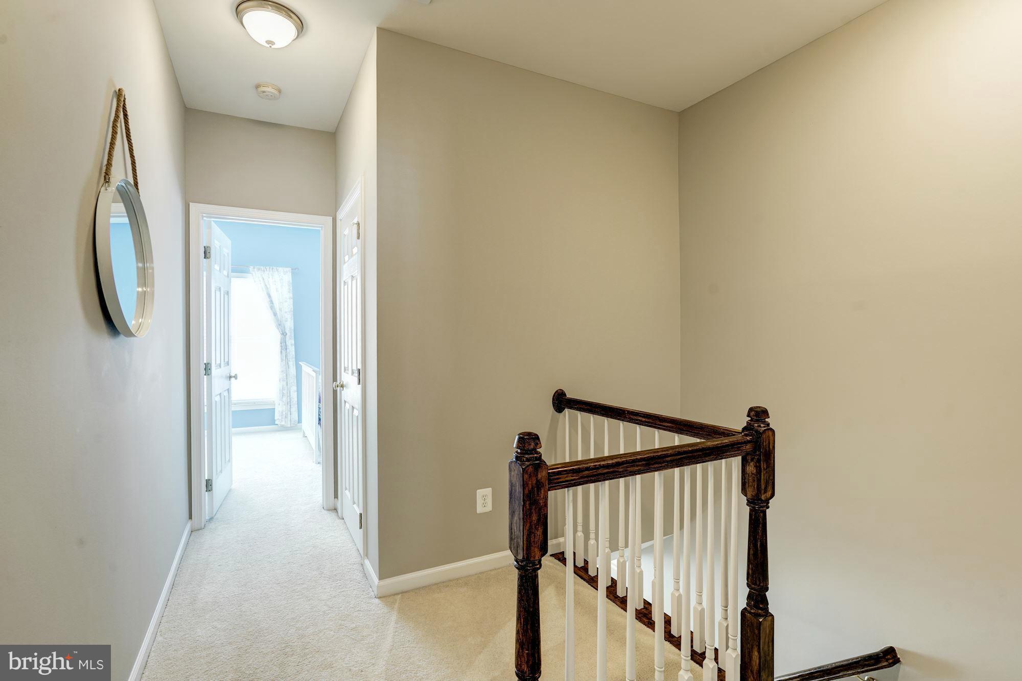 25013 Riding Center Drive Chantilly, VA 20152 - Photo 21 of 28 a view of a hallway with wooden floor and entryway