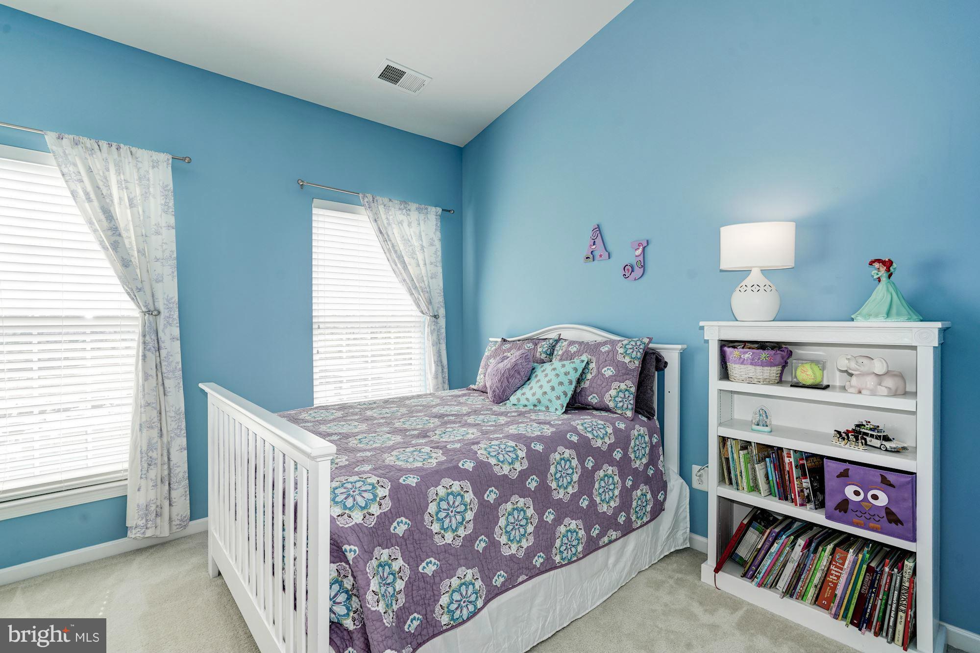 25013 Riding Center Drive Chantilly, VA 20152 - Photo 22 of 28 a bedroom with a bed and a book shelf