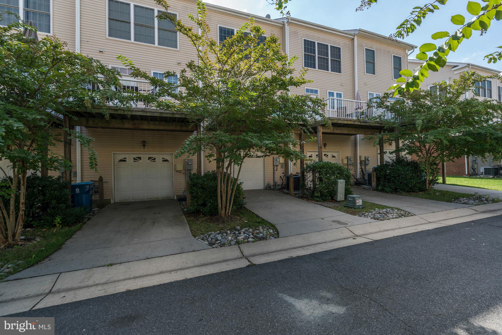 25013 Riding Center Drive Chantilly, VA 20152 - Photo 26 of 28 a front view of a house with a yard and potted plants