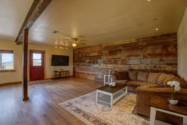 a living room with furniture and a flat screen tv