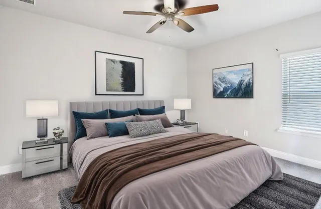 a bedroom with bed and a window