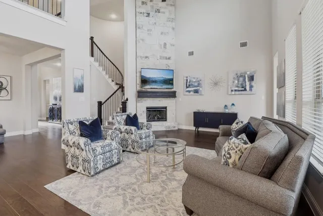 a living room with furniture fireplace and a flat screen tv