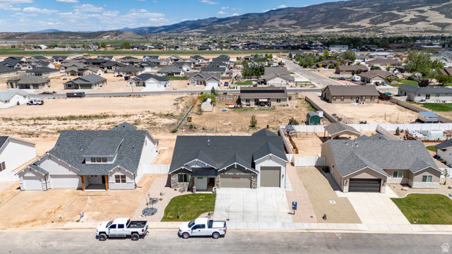 4978 North 75 East Enoch, UT 84721 - Photo 49 of 60 Contemporary single-story residence featuring a dark gray roof and a light-colored exterior with stone accents