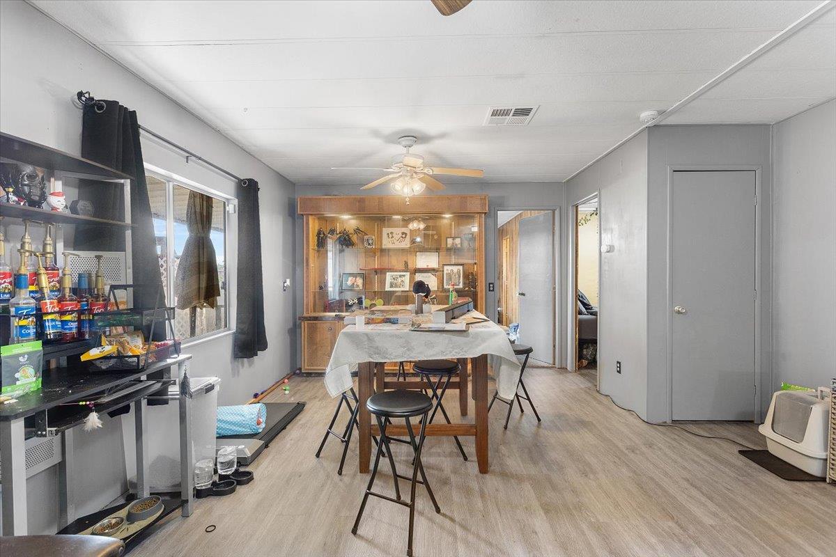4837 Faith Home Road, Unit 177 Ceres, CA 95307 - Photo 11 of 31 a view of a dining room with furniture window and wooden floor