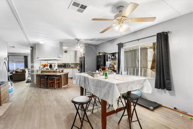 a living room with furniture a flat screen tv and a table