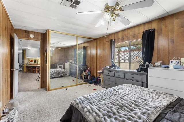 a large bedroom with a large bed and a chandelier