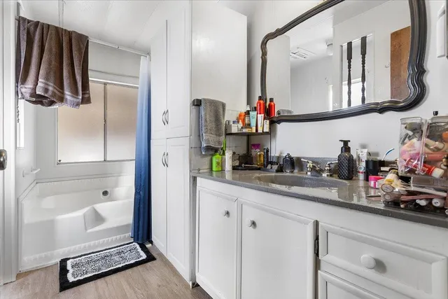 a kitchen with white cabinets and a sink