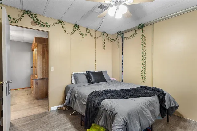 a bedroom with a bed and a mirror